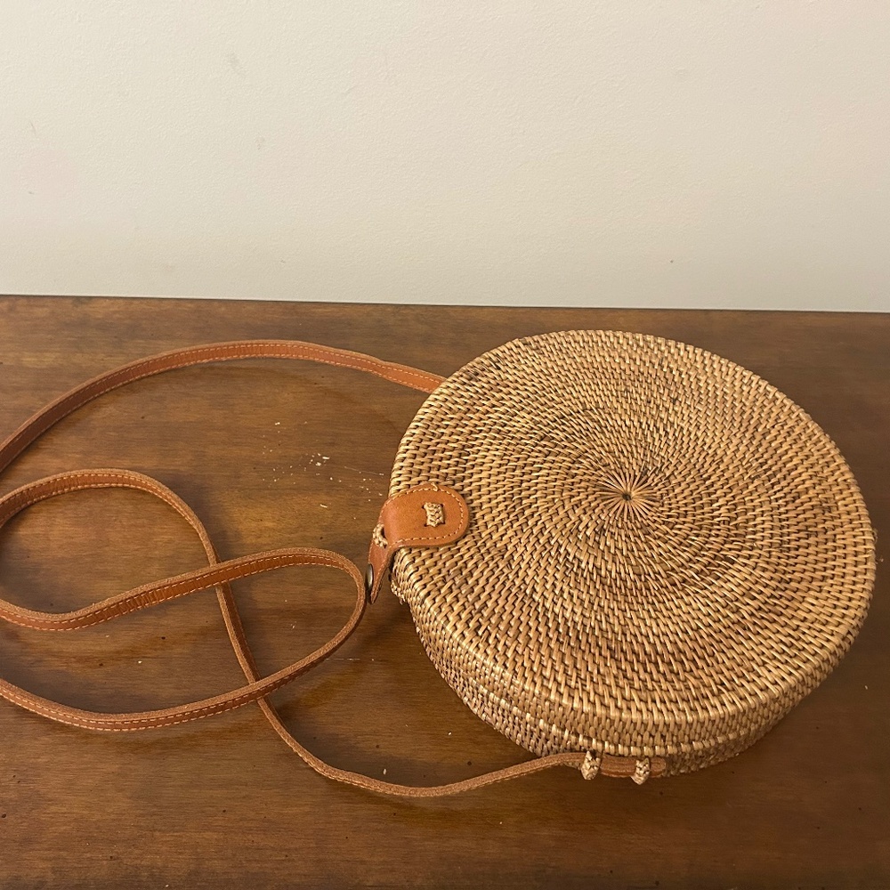 Round hand woven cross body Bali Bag. Lining is a unique purple fabric.